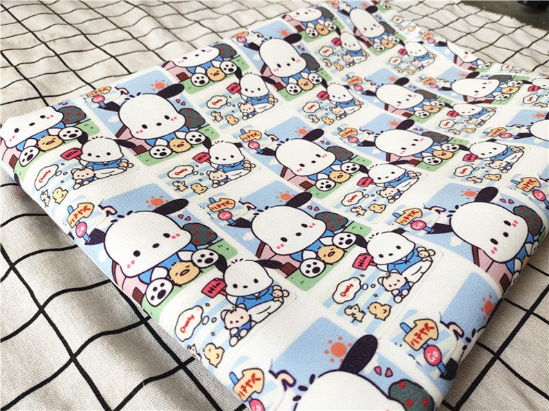 May include: White fabric with a repeating pattern of a cartoon dog wearing a blue shirt and holding a small yellow chick. The dog is surrounded by a blue and white border with Japanese text.