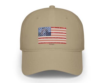 May include: A beige baseball cap with an American flag patch. The flag is a watercolor design with red, white, and blue colors. The text "BEAGLES" is printed below the flag.