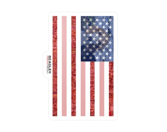 May include: A sticker featuring a red, white, and blue American flag. The flag is made up of small images of dogs. The text "BEAGLE FREEDOM PROJECT" is in the corner of the sticker.