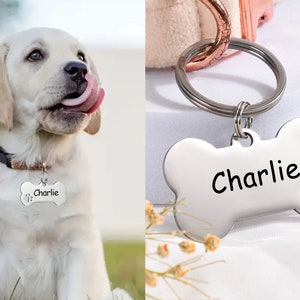 May include: A silver bone-shaped dog tag with the name "Charlie" engraved on it. The tag has a small paw print design on the side.