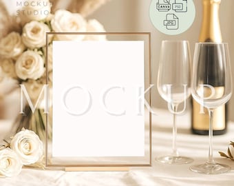May include: A gold-framed mockup with a blank white paper, champagne bottle, two wine glasses, and a bouquet of white roses. The image includes the text "MOCKUP" and file type icons.