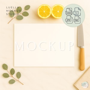 May include: A styled mockup scene with a cream-coloured rectangular card embossed with the word "MOCKUP". The scene includes two lemon halves, a knife with a wooden handle, and eucalyptus sprigs. A graphic shows file type icons.
