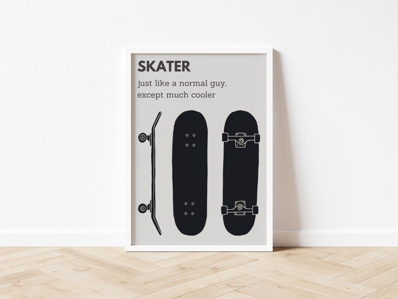 May include: A framed print featuring three black skateboard illustrations against a light gray background. The text "SKATER just like a normal guy, except much cooler" is at the top. The print is in a white frame and is displayed on a wooden floor.
