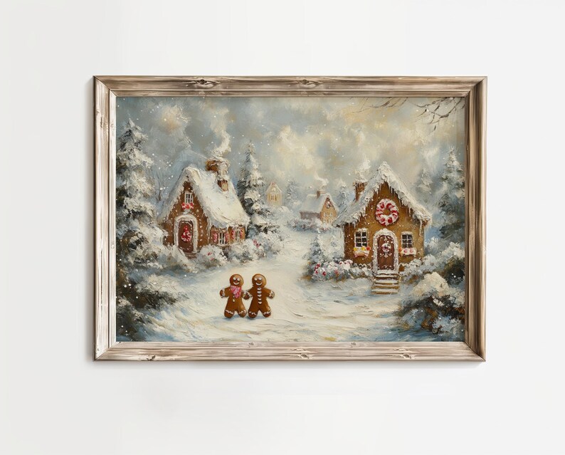 May include: A framed painting depicts a winter scene with snow-covered gingerbread houses and trees. Two gingerbread people stand on a snowy path. The artwork has a warm, inviting feel with soft colors and a rustic wooden frame.