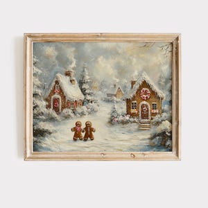 May include: A framed winter scene painting featuring two gingerbread people walking towards two snow-covered gingerbread houses. The houses have candy cane wreaths and snow-covered roofs. The painting is in a wooden frame.