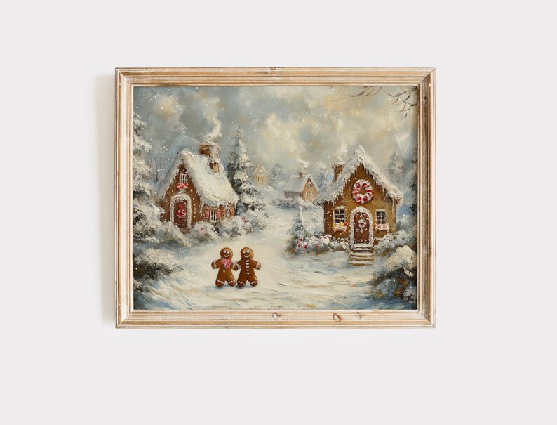 May include: A framed winter scene painting featuring two gingerbread people walking towards two snow-covered gingerbread houses. The houses have candy cane wreaths and snow-covered roofs. The painting is in a wooden frame.