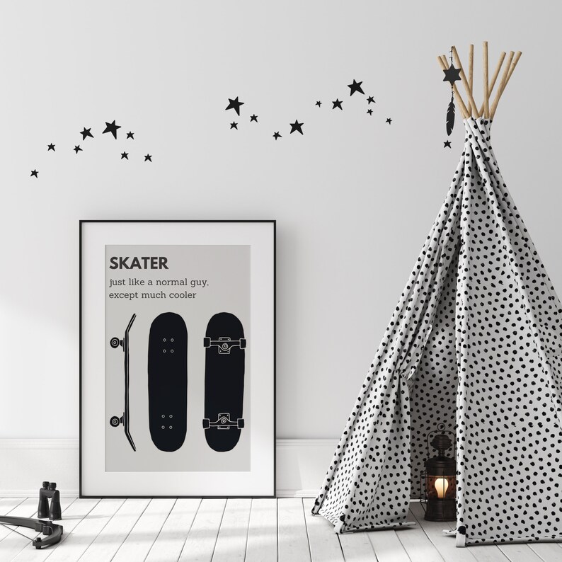 May include: A framed black and white print with the word "SKATER" and two skateboard illustrations. A black and white teepee with a dotted pattern stands to the right. Black star decals are on the white wall.