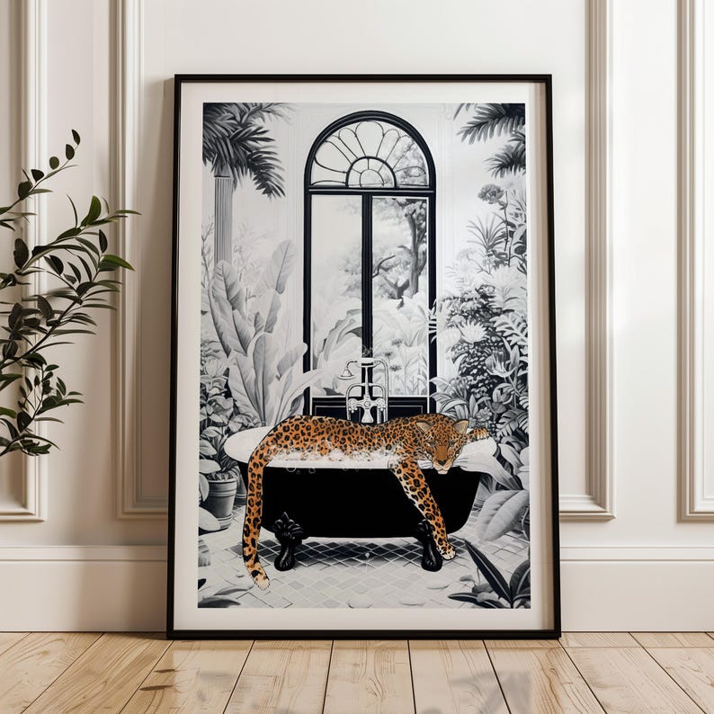 May include: A framed wall art print featuring a black and white illustration of a leopard resting in a clawfoot bathtub filled with bubbles. The scene is set in a lush, tropical indoor garden with a large arched window and palm trees.
