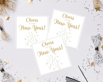 May include: Three white square cards with gold text that reads "Cheers to the New Year!" with champagne flutes and star illustrations. The cards are surrounded by gold stars and confetti.