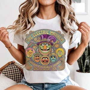 Muppet characters on a t-shirt with "The Electric Mayhem" and concert details.