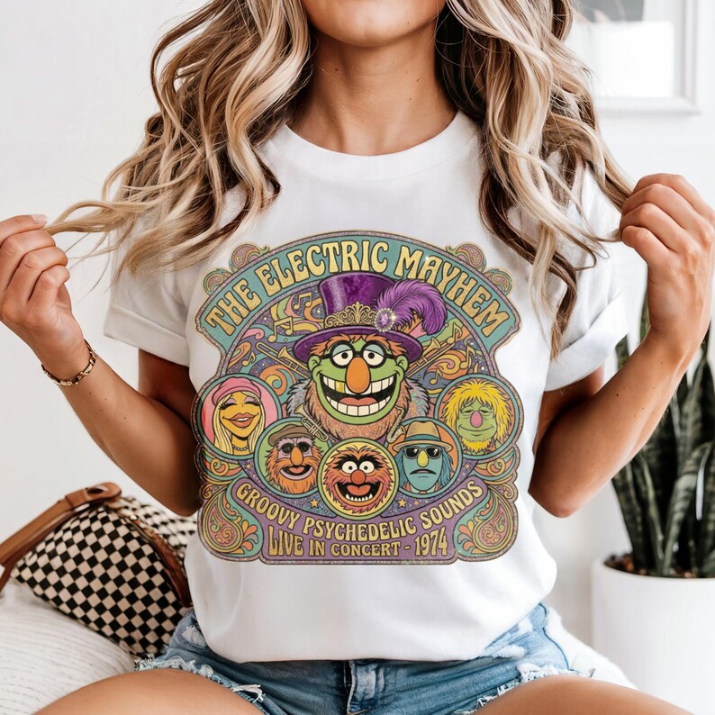 Muppet characters on a t-shirt with "The Electric Mayhem" and concert details.