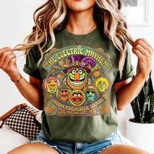 Green t-shirt with The Electric Mayhem "Groovy Psychedelic Sounds Live in Concert 1974" graphic.