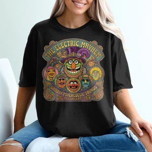 Black t-shirt with "The Electric Mayhem" and psychedelic Muppet characters concert graphic.