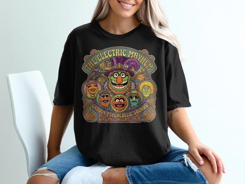 Black t-shirt with "The Electric Mayhem" and psychedelic Muppet characters concert graphic.