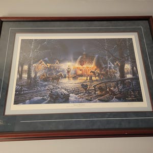 May include: A framed winter scene painting depicting a snowy village with a horse-drawn carriage, a small cottage with lit windows, and a snow-covered landscape. The painting is titled "Sweet Memories".