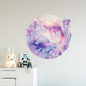 May include: A round wall decal featuring two watercolor koi fish in shades of purple, pink, and blue. The fish are surrounded by floral elements and set against a soft, dreamy background. The artwork evokes a sense of tranquility and beauty.