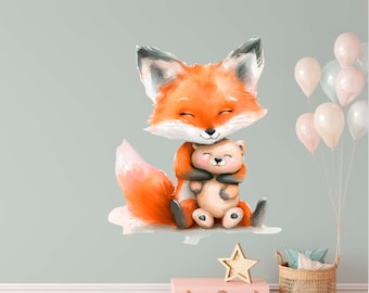 May include: A watercolor illustration of a cute orange fox holding a brown teddy bear. The fox has closed eyes and a big smile. The illustration is on a light blue background.