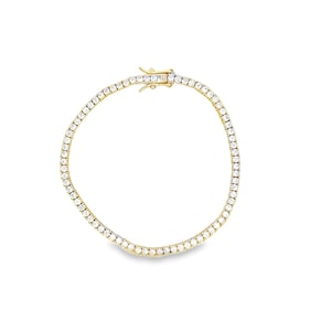May include: A gold tennis bracelet with a row of clear, round-cut gemstones. The bracelet features a secure clasp. The gemstones are set closely together, creating a continuous sparkle. The bracelet is displayed on a white background.