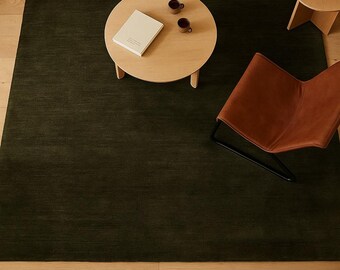 Handloom Wool Rug in deep olive moss green solid heathered area rug with hand-sheared low pile and natural wool texture low shed living room