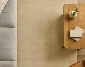 Handloom Wool Rug in warm ivory solid minimalist area rug with subtle heathered texture and soft hand-sheared low pile. Premium natural woo