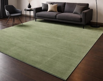 Handloom Wool Rug in rich moss/olive green, solid earthy area rug with heathered texture and soft hand-sheared low pile; minimalist Rug