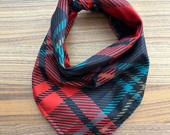 May include: A red, black, and teal plaid bandana with a knotted design.