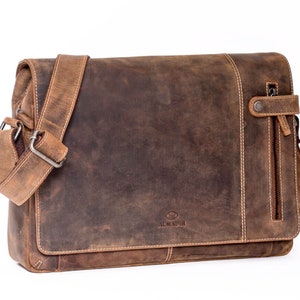 May include: A brown leather messenger bag with a zippered pocket and a strap. The bag has a distressed look and the brand name "ALMADIH" is embossed on the front.