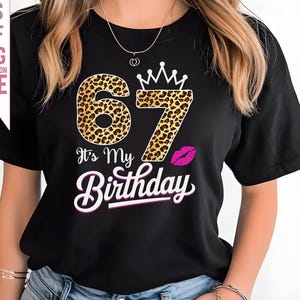 May include: Black t-shirt with a leopard print 67 and the text "It's My Birthday" in pink. A pink lip print is above the text.