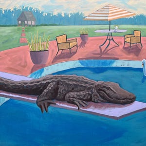 May include: A large alligator is relaxing on a diving board in a swimming pool. The pool is surrounded by a pink patio with two yellow chairs and a table with an umbrella. A white swan float is in the pool.