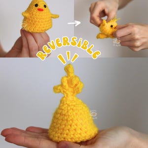 May include: A handmade, reversible yellow crochet chick toy. The chick transforms into a yellow pouch. The word "REVERSIBLE" is written in yellow script. The chick has a red beak and small yellow hair.