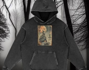May include: A black hooded sweatshirt with a vintage-style graphic print of a jack-o'-lantern moon and a spooky silhouette in front of a tower.