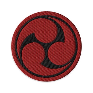 May include: Red embroidered patch with a black three-part circle design. The design is a traditional Japanese symbol.