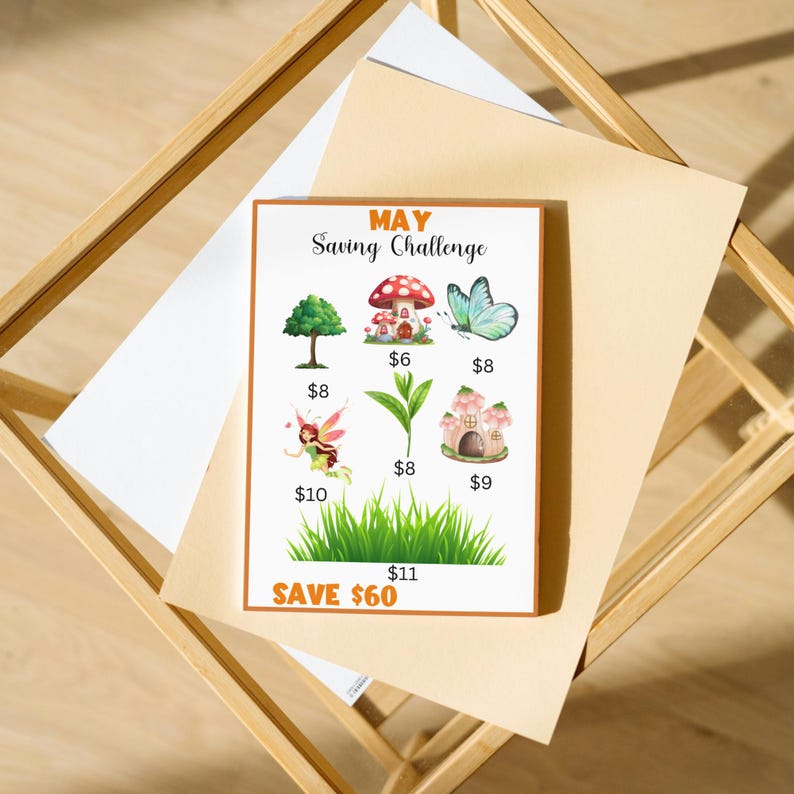 The image is a poster or flyer for a saving challenge, featuring illustrations of a mushroom house, a butterfly, a tree, a fairy, a grass plant, and a mushroom house. The poster includes text and illustrations related to the saving challenge, and it is placed on a wooden surface.