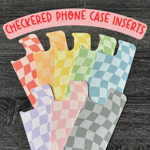May include: Checkered phone case inserts in a variety of colors, including orange, yellow, green, blue, purple, pink, and gray. The inserts are designed to fit inside a phone case and add a pop of color and style.