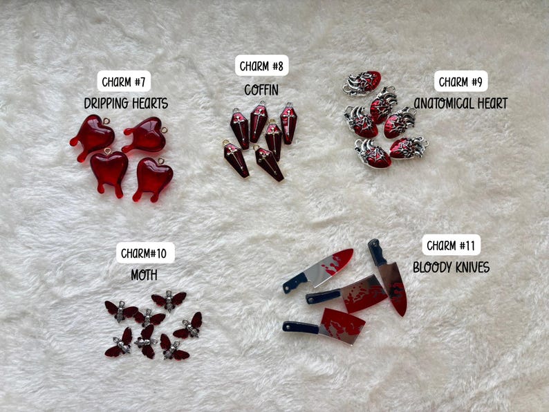 May include: A collection of charms with a gothic theme. Includes red dripping hearts, coffin shapes, anatomical hearts, moth shapes, and bloody knives. Each charm is detailed and has a unique design.