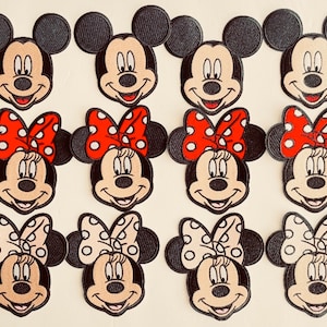 May include: Embroidered patches featuring Mickey Mouse and Minnie Mouse. Mickey patches have black ears and a smiling face. Minnie patches have red or cream-colored bows with white polka dots. The patches are on a cream-colored background.