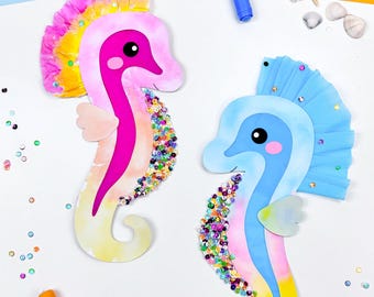 May include: Two colorful seahorse cutouts with sequin accents. One seahorse is pink, yellow, and purple, the other is blue, pink, and yellow. Markers, seashells, and starfish are scattered around the seahorses on a white background.