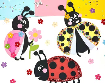 May include: Three paper ladybugs with different colored wings and black spots. The ladybugs are on a white background with pink, blue, and yellow paper behind them. There are also small paper flowers and butterflies scattered around the ladybugs.