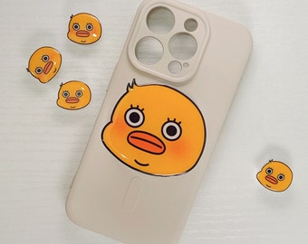 May include: A white phone case with a yellow duck sticker on it. The phone case has a camera lens cutout with multiple circles. There are four smaller yellow duck stickers around the phone case.