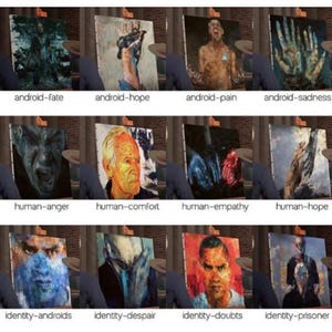 May include: A series of twelve paintings on easels, each depicting a human or android emotion. The paintings are labeled with phrases such as "android-fate", "human-anger", and "identity-prisoner". The artwork is displayed in a gallery setting.