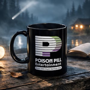 May include: Black ceramic mug featuring the text "POISON PILL Entertainment" and a stylized "P" logo in white, green, and purple. The mug is on a wooden surface with a flashlight, open book, and radio in the background.