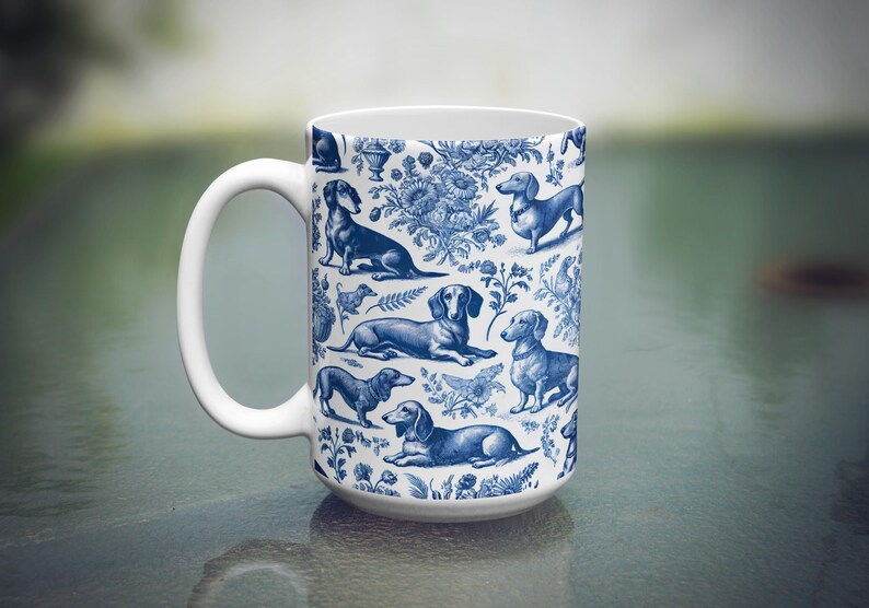 May include: A white ceramic coffee mug featuring a blue and white pattern of dachshunds. The dachshunds are depicted in various poses, including sitting, standing, and running. The mug has a large handle.