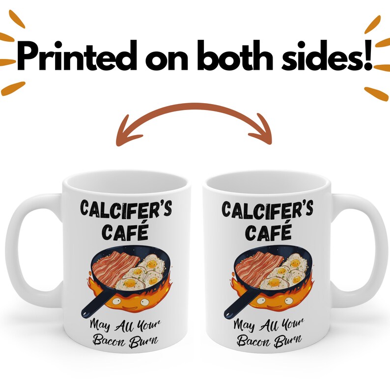 May include: White ceramic mug with a black and white illustration of a cartoon fire demon holding a frying pan with bacon and eggs. The text "CALCIFER'S CAFE" is printed in black above the illustration. The text "May All Your Bacon Burn" is printed in black below the illustration.