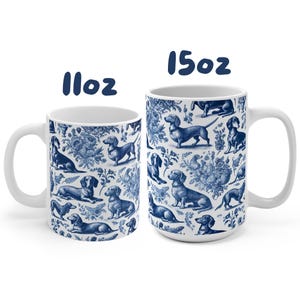 May include: Two white ceramic mugs with a blue and white pattern of dachshunds. The mugs are 11oz and 15oz.