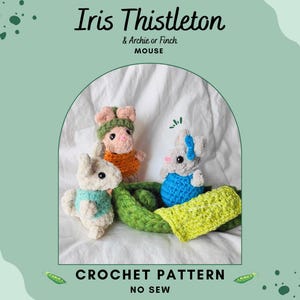 May include: Three crocheted mouse toys in a whimsical scene. One mouse is white with a blue vest, another is pink with an orange top and green hat, and the third is gray with a blue dress and bow. The text reads "Iris Thistleton & Archie or Finch MOUSE CROCHET PATTERN NO SEW."