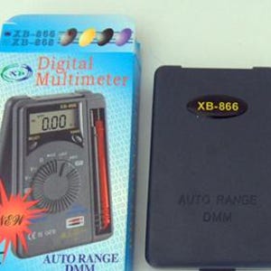 May include: A digital multimeter model XB-866 with a dark gray casing, featuring a digital display showing 0.00, a central rotary dial, and a red probe. The device is presented alongside its blue retail box with the text Digital Multimeter.