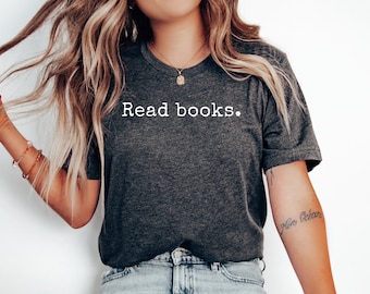 May include: A dark gray t-shirt with the text "Read books." printed in white on the front.
