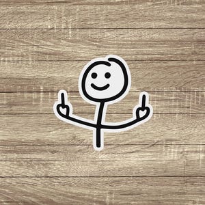 May include: A white sticker featuring a stick figure with a smiling face and arms raised, displaying both middle fingers. The design has a black outline and is set against a wooden background.