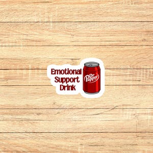 May include: A white sticker with red text that says "Emotional Support Drink" and a red and white Dr Pepper can.