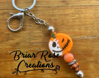 Llavero de esqueleto de calabaza de dos caras